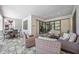 Stylish covered patio with comfortable seating and dining area for outdoor gatherings at 12370 Marsh Pointe Rd, Sarasota, FL 34238