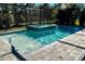 Sparkling pool and integrated spa, surrounded by lush landscaping, offer a private outdoor oasis at 12370 Marsh Pointe Rd, Sarasota, FL 34238