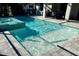 A rectangular pool features a baja shelf and a spa with mosaic tile surround at 12370 Marsh Pointe Rd, Sarasota, FL 34238