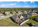 Aerial perspective of the property with a screened-in lanai, set against a backdrop of lush greenery at 13065 Bliss Loop, Bradenton, FL 34211