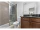 Bathroom featuring a glass shower, dark countertop, and light tiled floors at 13065 Bliss Loop, Bradenton, FL 34211