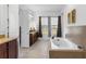 Luxurious bathroom featuring a soaking tub, double vanity, and granite countertops at 13065 Bliss Loop, Bradenton, FL 34211