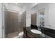 Bathroom featuring a glass shower, dark countertop, and light tiled floors at 13065 Bliss Loop, Bradenton, FL 34211