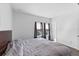 Bedroom featuring hardwood floors, a large bed, and large windows with dark curtains at 13065 Bliss Loop, Bradenton, FL 34211