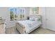 Bedroom with shuttered windows, light wood floors and a decorative painting at 13065 Bliss Loop, Bradenton, FL 34211