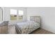Bedroom featuring wood-look flooring and light walls, with backyard views at 13065 Bliss Loop, Bradenton, FL 34211