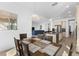 Open dining area with wood table and seating, flowing into the living space with a view of the kitchen at 13065 Bliss Loop, Bradenton, FL 34211