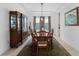 Formal dining room with tray ceiling, elegant wood furniture, and large area rug at 13065 Bliss Loop, Bradenton, FL 34211
