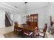 Elegant dining room featuring tray ceilings, decorative lighting, and staircase access at 13065 Bliss Loop, Bradenton, FL 34211