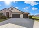 Beautiful two-story home featuring a spacious three car garage and manicured front lawn at 13065 Bliss Loop, Bradenton, FL 34211