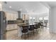 Open kitchen area features bar seating, a dining table, stainless steel appliances and neutral color scheme at 13065 Bliss Loop, Bradenton, FL 34211