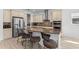 Gourmet kitchen featuring stainless steel appliances, breakfast bar with seating and stylish backsplash at 13065 Bliss Loop, Bradenton, FL 34211