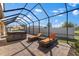 Enclosed patio featuring a relaxing hot tub and lounge chairs perfect for outdoor leisure at 13065 Bliss Loop, Bradenton, FL 34211