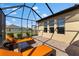 Enclosed patio featuring sleek lounge chairs with sunny backyard views at 13065 Bliss Loop, Bradenton, FL 34211