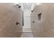 Walk-in shower featuring dual shower heads and tile surround with recessed shelf at 13065 Bliss Loop, Bradenton, FL 34211