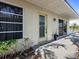 Quaint back porch with sliding glass door offering tranquil waterfront views and peaceful outdoor living at 1374 Moonmist Dr # B1, Sarasota, FL 34242