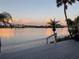 Beautiful waterfront view with a patio and palm trees offering a serene and tropical backyard setting at 1374 Moonmist Dr # B1, Sarasota, FL 34242
