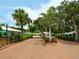 View of a paved road lined with trees and lush greenery leading through the community at 1374 Moonmist Dr # B1, Sarasota, FL 34242