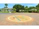 Welcome to the community, featuring a beautifully decorated brick entrance surrounded by lush landscaping at 1374 Moonmist Dr # B1, Sarasota, FL 34242