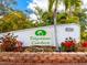Polynesian Gardens Community sign with tropical plants and foliage surrounding at 1374 Moonmist Dr # B1, Sarasota, FL 34242