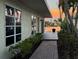 Charming home exterior featuring a brick walkway, lush greenery, and serene water views at 1374 Moonmist Dr # B1, Sarasota, FL 34242