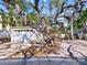 Charming home exterior with a spacious two-car garage and mature trees providing ample shade at 1374 Moonmist Dr # B1, Sarasota, FL 34242