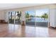 Living room with tile floors and large sliding glass doors showcasing a water view at 1374 Moonmist Dr # B1, Sarasota, FL 34242