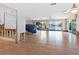 Large living area featuring tile floors, ceiling fans and expansive water views through sliding glass doors at 1374 Moonmist Dr # B1, Sarasota, FL 34242