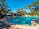 Enjoy the community pool surrounded by mature trees, tables, and plenty of lounge chairs at 1374 Moonmist Dr # B1, Sarasota, FL 34242