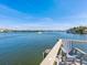 Waterfront view from pier with boat cruising and blue skies at 1374 Moonmist Dr # B1, Sarasota, FL 34242