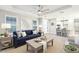 Well-lit living room featuring a plush blue sofa, stylish coffee table, and an open layout at 14671 Derna Ter, Bradenton, FL 34211