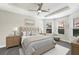 Relaxing main bedroom with a tray ceiling, ceiling fan and large windows that stream in natural light at 14671 Derna Ter, Bradenton, FL 34211