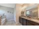 Bathroom featuring double sink vanity with granite countertops and tile flooring at 15008 Trinity Fall Way, Bradenton, FL 34212