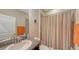 Cozy bathroom featuring granite countertop, modern fixtures, and shower with striped curtain at 15008 Trinity Fall Way, Bradenton, FL 34212
