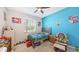 Bright bedroom featuring a bed, rocking chair and large window at 15008 Trinity Fall Way, Bradenton, FL 34212