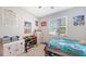 Comfortable bedroom with a large window and a toy storage unit at 15008 Trinity Fall Way, Bradenton, FL 34212