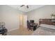 Cozy bedroom has a bed with storage, desk, and a ceiling fan at 15008 Trinity Fall Way, Bradenton, FL 34212