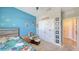 bedroom features a bed, rocker and a large closet at 15008 Trinity Fall Way, Bradenton, FL 34212
