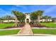 Beautiful community clubhouse with lush landscaping, well-maintained lawns, and sidewalks at 15008 Trinity Fall Way, Bradenton, FL 34212