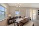 Dining area with large window, stylish chandelier, and comfortable seating for Gathering meals at 15008 Trinity Fall Way, Bradenton, FL 34212