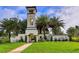 Welcoming entrance to the community with stone tower, lush landscaping, and well-maintained grounds at 15008 Trinity Fall Way, Bradenton, FL 34212