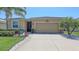 Inviting home with a well-kept lawn, palm tree and a spacious two-car garage at 15008 Trinity Fall Way, Bradenton, FL 34212