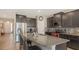 Bright kitchen with granite countertops, stainless appliances, and breakfast bar seating at the island at 15008 Trinity Fall Way, Bradenton, FL 34212