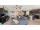 Spacious living room open to kitchen featuring a large sectional sofa and breakfast bar at 15008 Trinity Fall Way, Bradenton, FL 34212