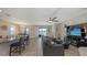 Open concept living area with a ceiling fan, tile flooring and sliding glass doors at 15008 Trinity Fall Way, Bradenton, FL 34212