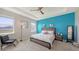 Cozy primary bedroom features tray ceilings, neutral decor, and bright, natural light at 15008 Trinity Fall Way, Bradenton, FL 34212