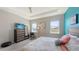 Primary bedroom offers dual windows, tray ceilings, ceiling fan, and plush carpeting at 15008 Trinity Fall Way, Bradenton, FL 34212