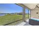 Beautiful screened patio offers serene views of the lush lawn and sparkling lake at 15008 Trinity Fall Way, Bradenton, FL 34212