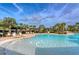 Zero entry community pool with sun loungers, trellises, and fountain features at 15008 Trinity Fall Way, Bradenton, FL 34212