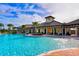 Gorgeous community pool with sun loungers, covered seating, and manicured landscaping at 15008 Trinity Fall Way, Bradenton, FL 34212